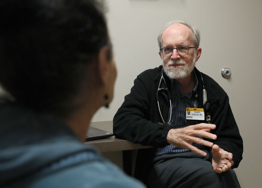 Dr. Daniel Vinson talks to a patient with opiate addiction at the Phoenix Health Programs clinic